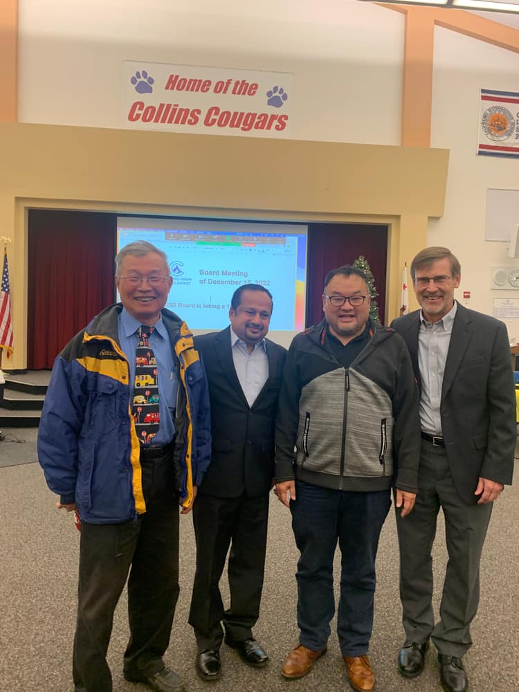 Satheesh Madhathil with colleagues at a district board meeting held at Collins Elementary School