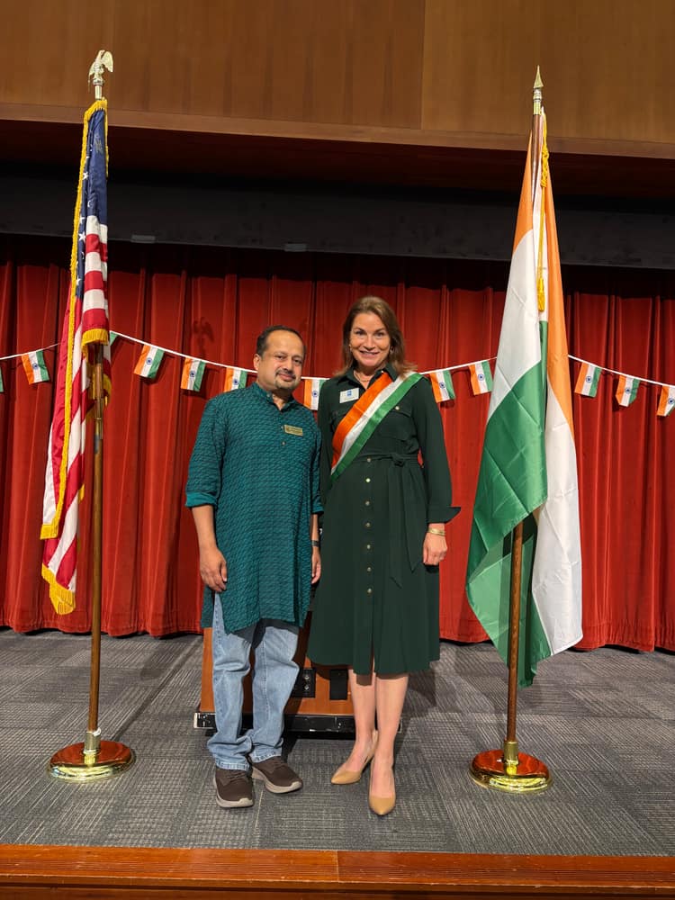 Satheesh Madhathil at a community celebration between the United States and Indian flags