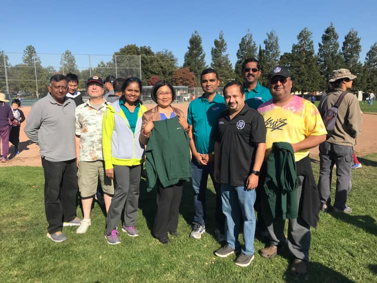 Satheesh Madhathil with volunteers at a community event in a local park