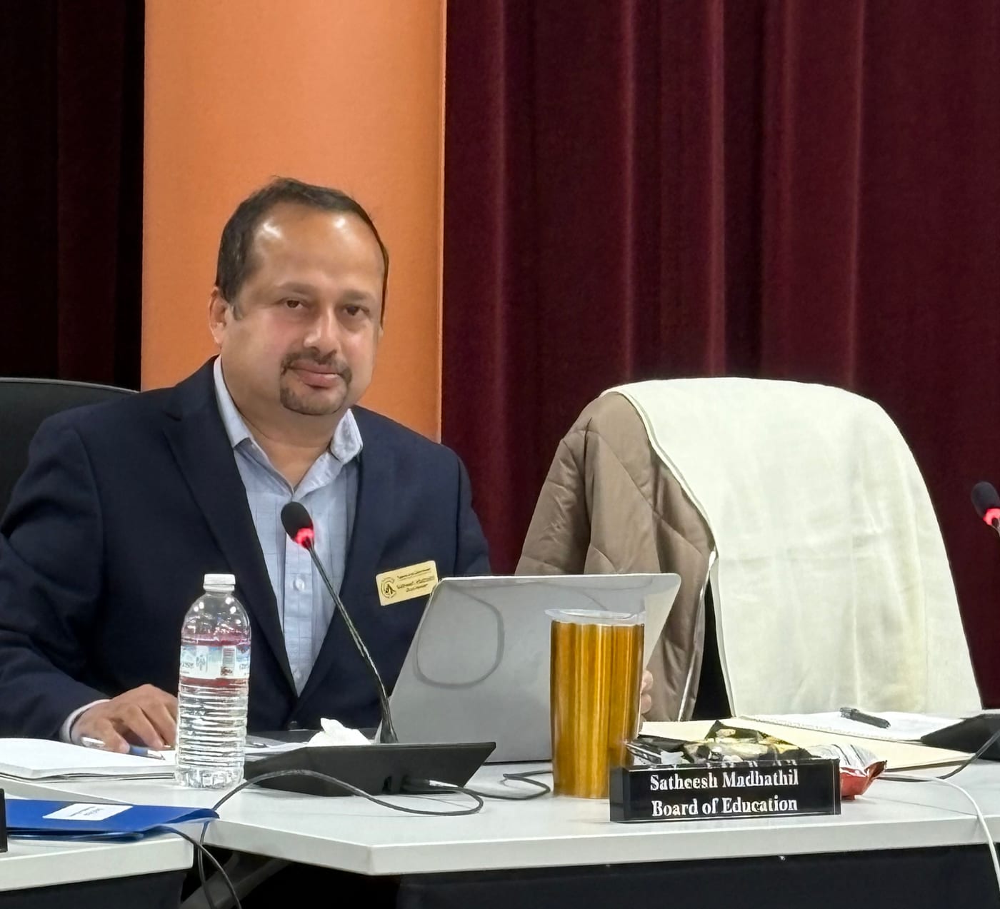 Satheesh Madhathil at the Cupertino Union School District board dais during a board meeting